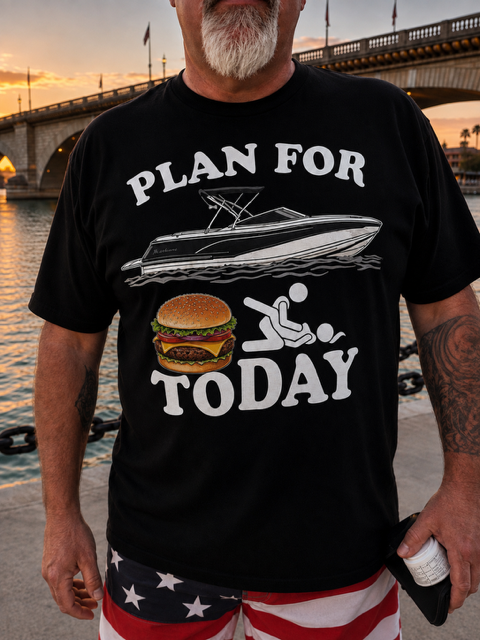 Man wearing black Plan For Today burger and boat print t-shirt at London Bridge