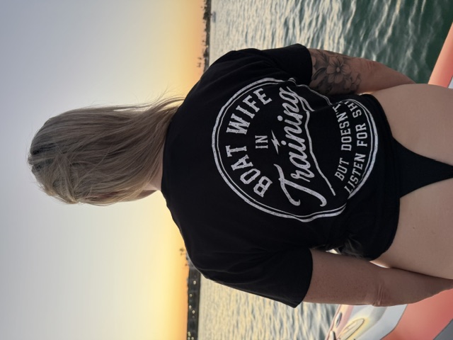 Woman wearing black Boat Wife In Training crop top on the water