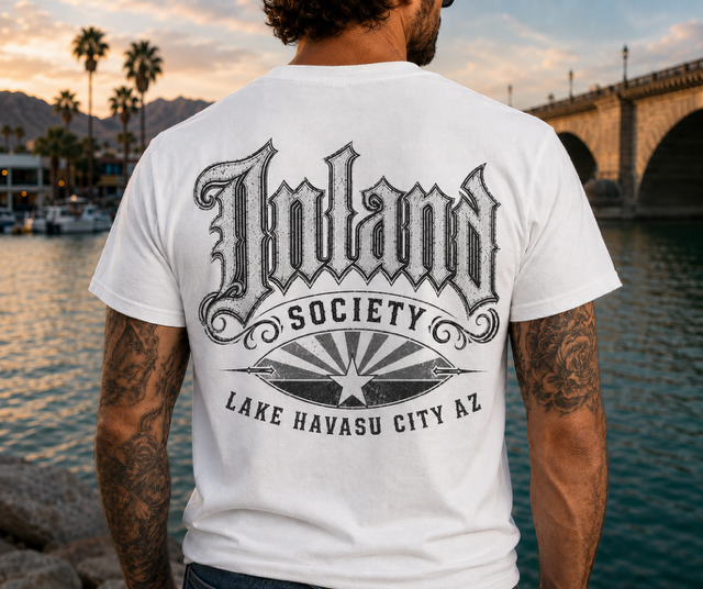 Man wearing white Inland Society Arizona flag logo t-shirt