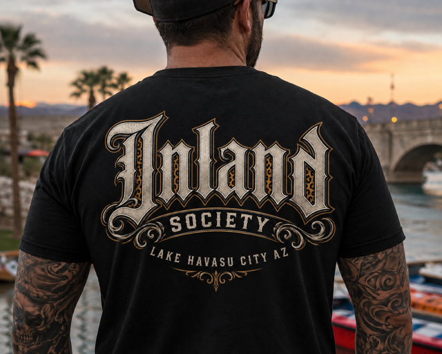 Man wearing black Inland Society t-shirt with leopard print logo at Lake Havasu