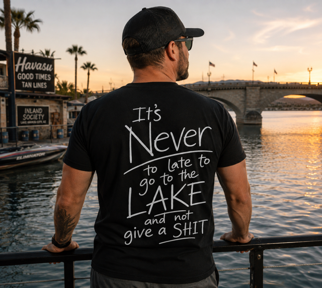 Man wearing a black Never Too Late t-shirt beside the London Bridge in Lake Havasu City